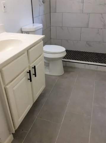 a bathroom with a toilet and a tub