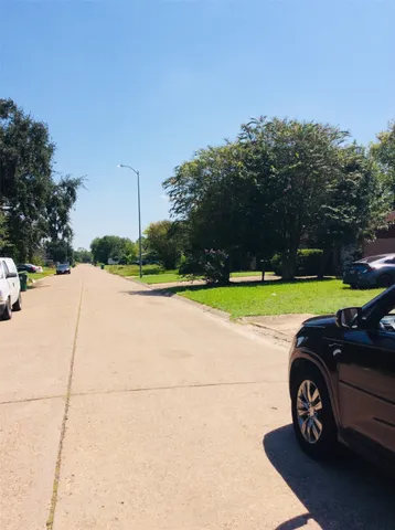 a view of a car is parked in a yard