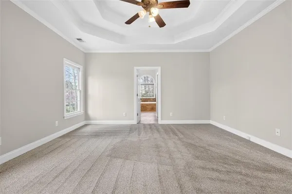 a spacious bathroom with a tub shower and a sink