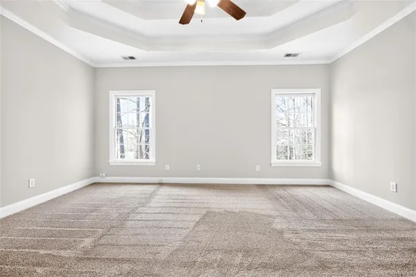 a spacious bathroom with a tub sink and mirror