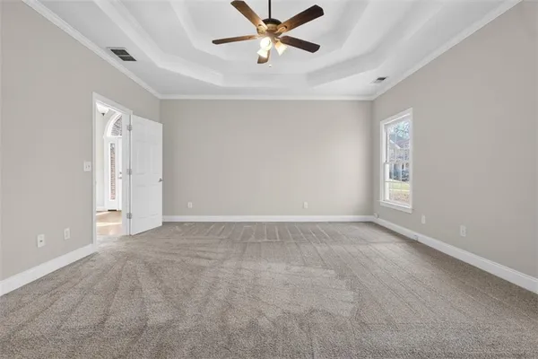 a white bath tub sitting next to a shower