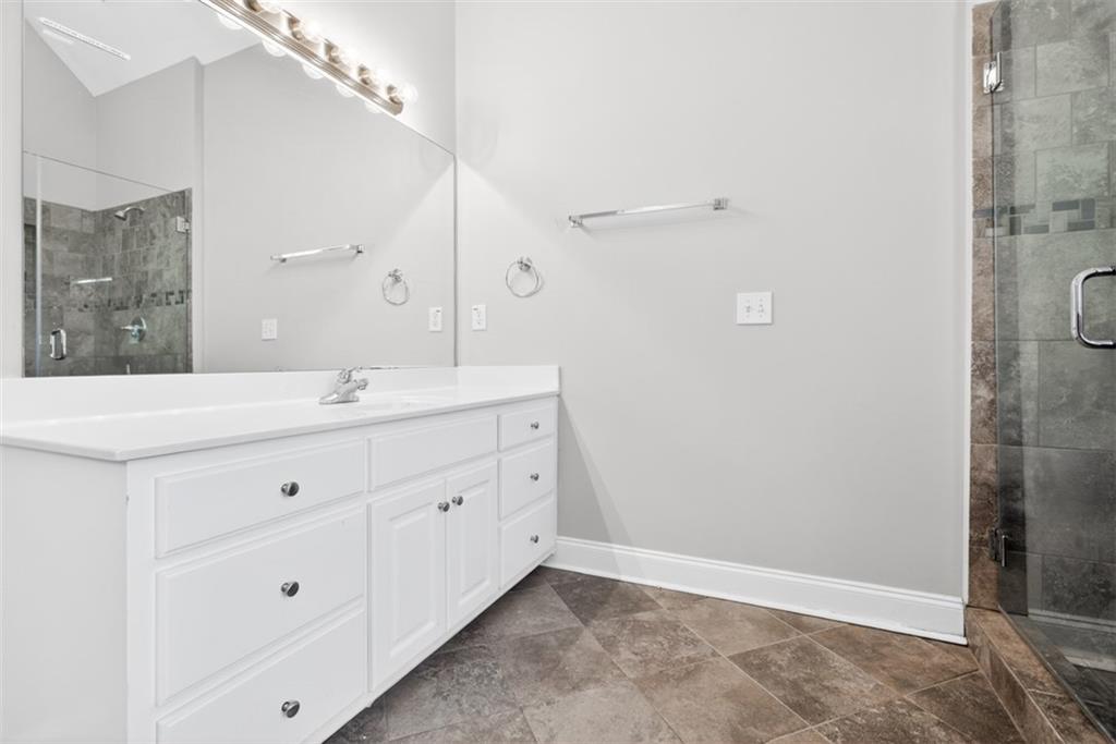 3570 Bulloch Lake Road Loganville, GA 30052 - Photo 21 of 71 a bathroom with a double vanity sink and mirror
