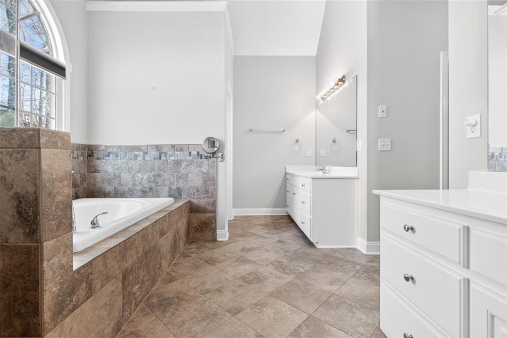 3570 Bulloch Lake Road Loganville, GA 30052 - Photo 22 of 71 a spacious bathroom with a tub sink and mirror