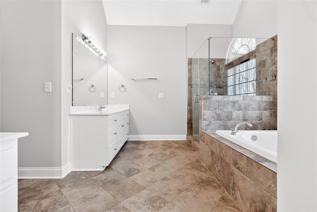 3570 Bulloch Lake Road Loganville, GA 30052 - Photo 23 of 71 a bathroom with a bathtub and a sink
