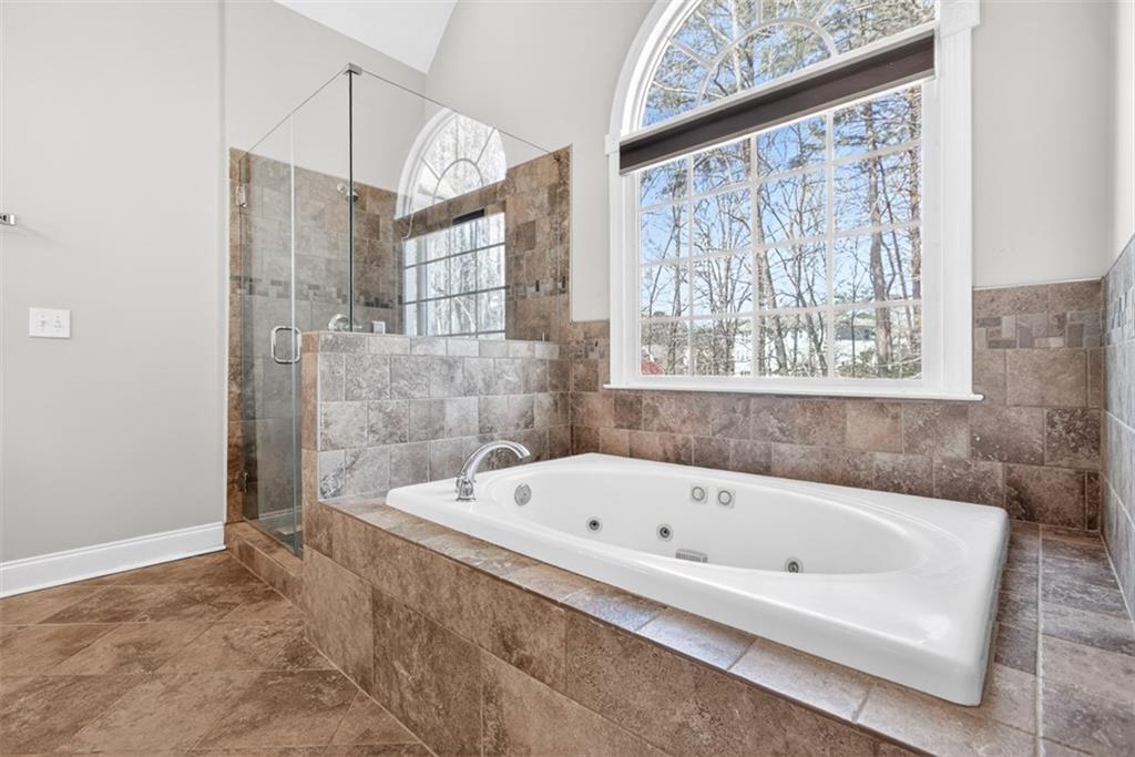 3570 Bulloch Lake Road Loganville, GA 30052 - Photo 25 of 71 a white bath tub sitting next to a shower