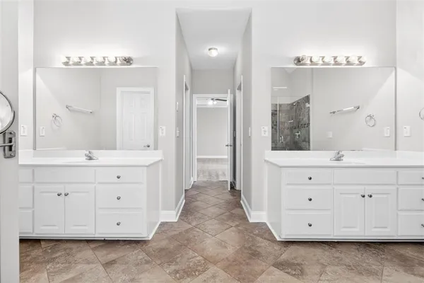 a kitchen with stainless steel appliances a white stove top oven and white cabinets