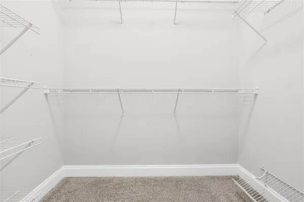 a kitchen with stainless steel appliances granite countertop white cabinets and a sink