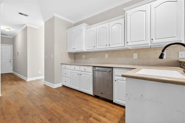 an empty room with chandelier fan and windows
