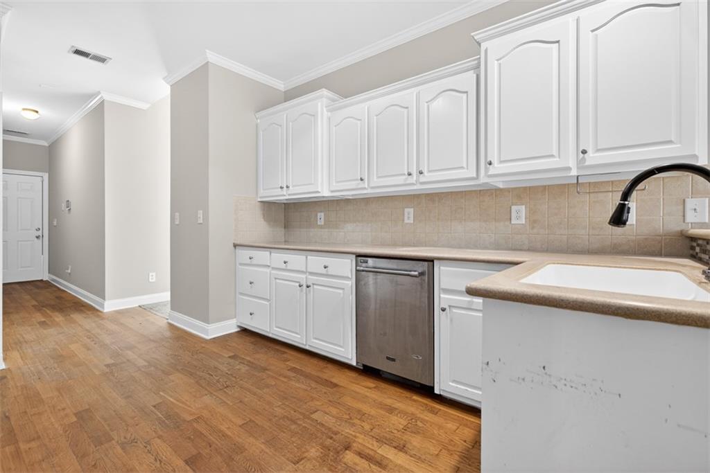 3570 Bulloch Lake Road Loganville, GA 30052 - Photo 32 of 71 a kitchen with granite countertop white cabinets and sink