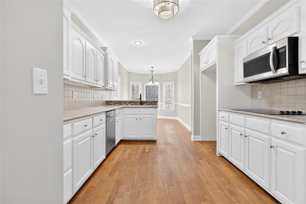 3570 Bulloch Lake Road Loganville, GA 30052 - Photo 33 of 71 a kitchen with stainless steel appliances a white stove top oven and white cabinets