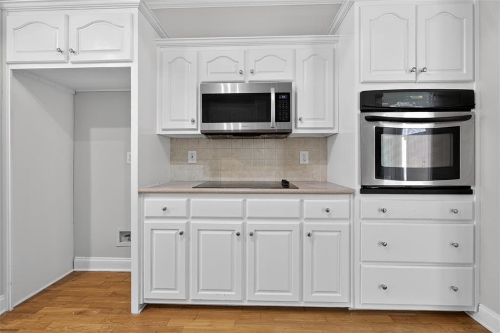 3570 Bulloch Lake Road Loganville, GA 30052 - Photo 34 of 71 a kitchen with stainless steel appliances granite countertop white cabinets and a sink
