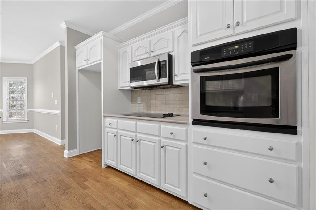 3570 Bulloch Lake Road Loganville, GA 30052 - Photo 35 of 71 a kitchen with white cabinets stainless steel appliances and sink