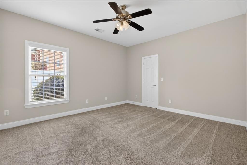 3570 Bulloch Lake Road Loganville, GA 30052 - Photo 39 of 71 an empty room with windows and fan