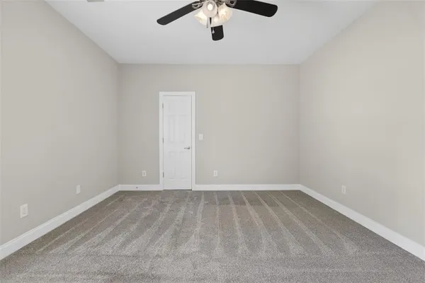 a view of a big room with closet and windows