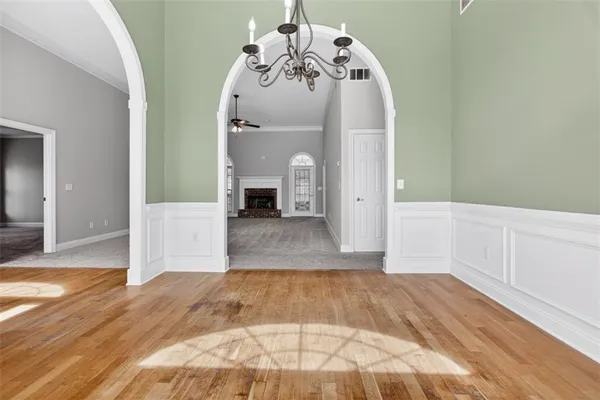 a view of an empty room with a fireplace and a window
