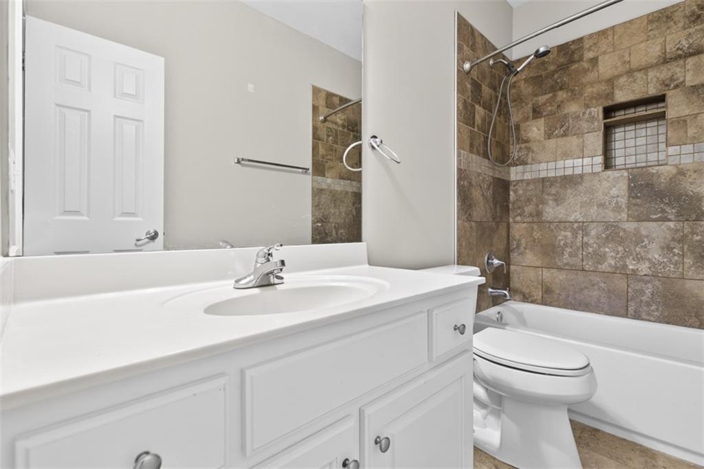 3570 Bulloch Lake Road Loganville, GA 30052 - Photo 42 of 71 a bathroom with a sink a toilet and a bathtub