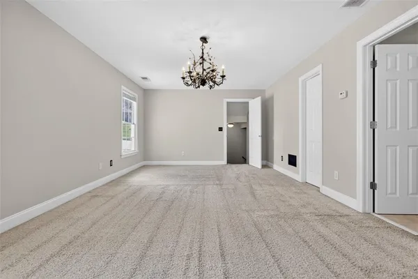a view of a livingroom with a ceiling fan and window