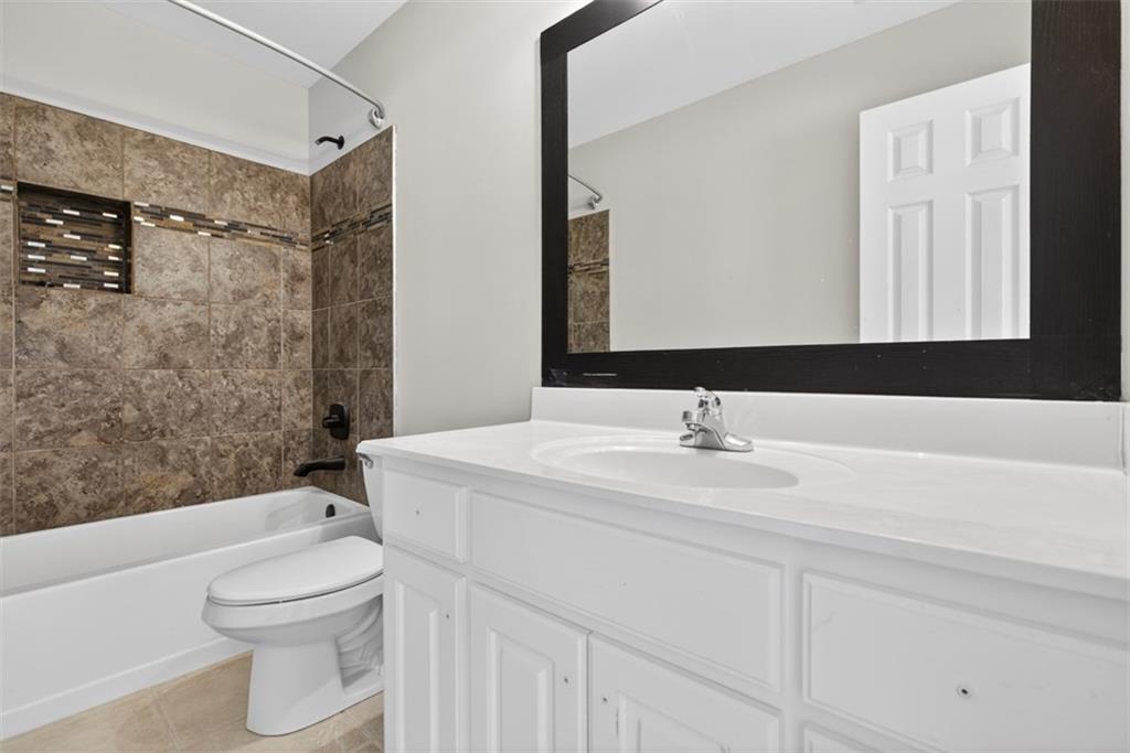 3570 Bulloch Lake Road Loganville, GA 30052 - Photo 48 of 71 a bathroom with a sink a toilet and shower