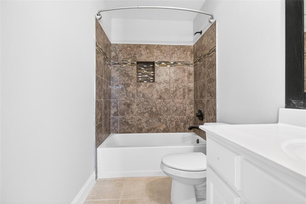 3570 Bulloch Lake Road Loganville, GA 30052 - Photo 49 of 71 a bathroom with a sink a toilet and bathtub