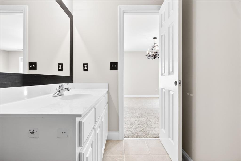 3570 Bulloch Lake Road Loganville, GA 30052 - Photo 50 of 71 a bathroom with a sink and a mirror