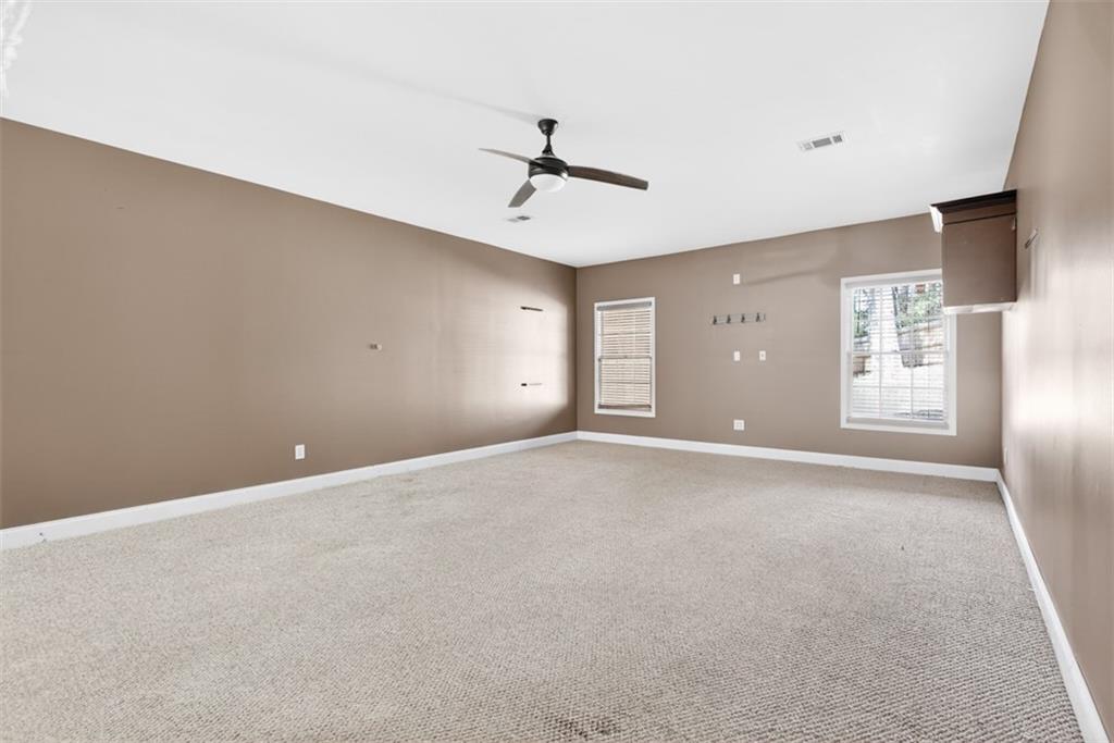 3570 Bulloch Lake Road Loganville, GA 30052 - Photo 61 of 71 an empty room with windows and fan