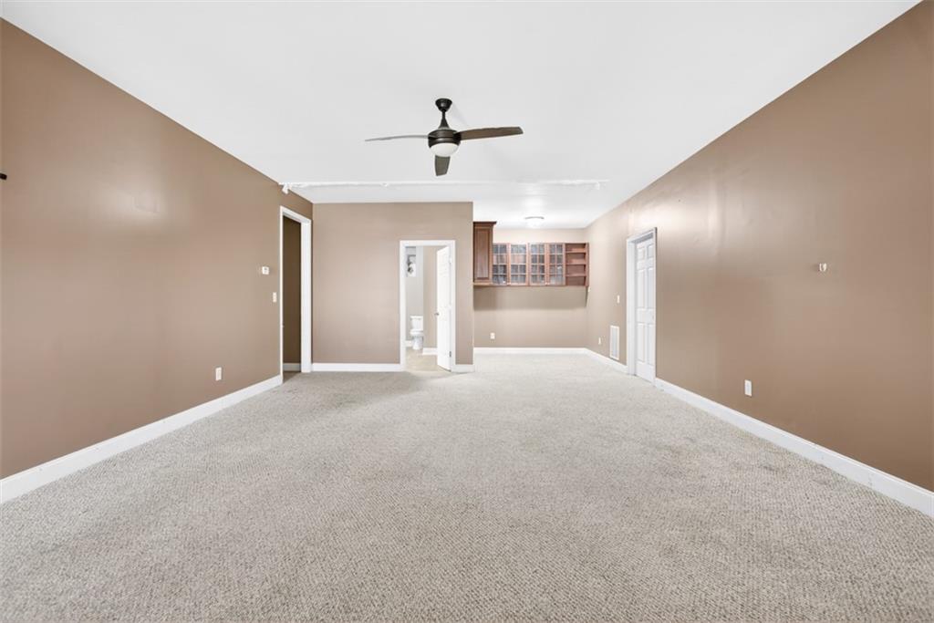 3570 Bulloch Lake Road Loganville, GA 30052 - Photo 62 of 71 a view of a livingroom with a ceiling fan and window
