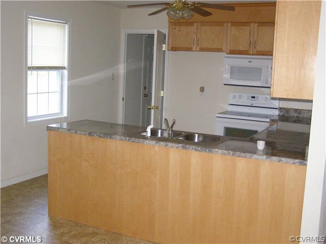 6350 Railroad Bed Road Carson, VA 23830 - Photo 4 of 12 a view of a kitchen with wooden floor and cabinets