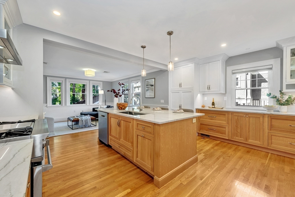 58 Bacon Street Winchester, MA 01890 - Photo 11 of 40 a large kitchen with kitchen island a large counter top space a sink stainless steel appliances and cabinets