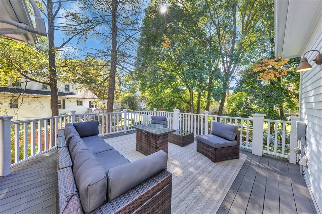 58 Bacon Street Winchester, MA 01890 - Photo 17 of 40 a view of a patio with couches chairs and wooden floor