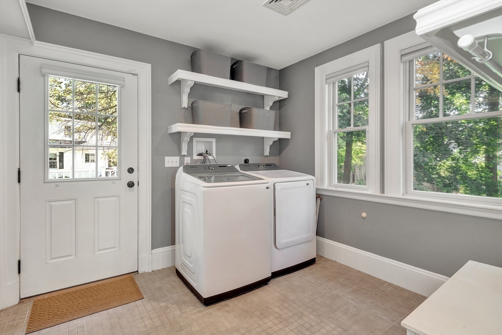 58 Bacon Street Winchester, MA 01890 - Photo 18 of 40 a utility room with dryer washer and a window