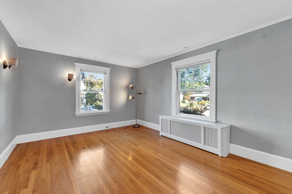 58 Bacon Street Winchester, MA 01890 - Photo 23 of 40 wooden floor in an empty room with a window