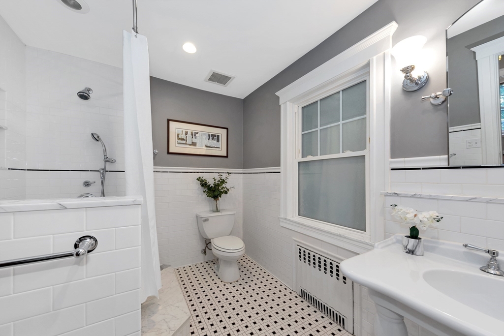 58 Bacon Street Winchester, MA 01890 - Photo 25 of 40 a bathroom with a sink a toilet and shower