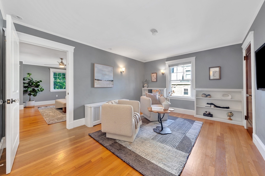 58 Bacon Street Winchester, MA 01890 - Photo 26 of 40 a living room with furniture a table and wooden floor