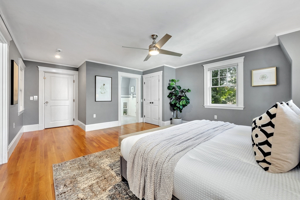 58 Bacon Street Winchester, MA 01890 - Photo 28 of 40 a bedroom with a large bed and a chandelier