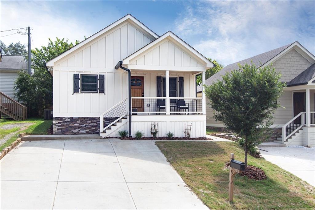 110 Strippling Street Ball Ground, GA 30107 - Photo 1 of 1 a front view of a house with a garden