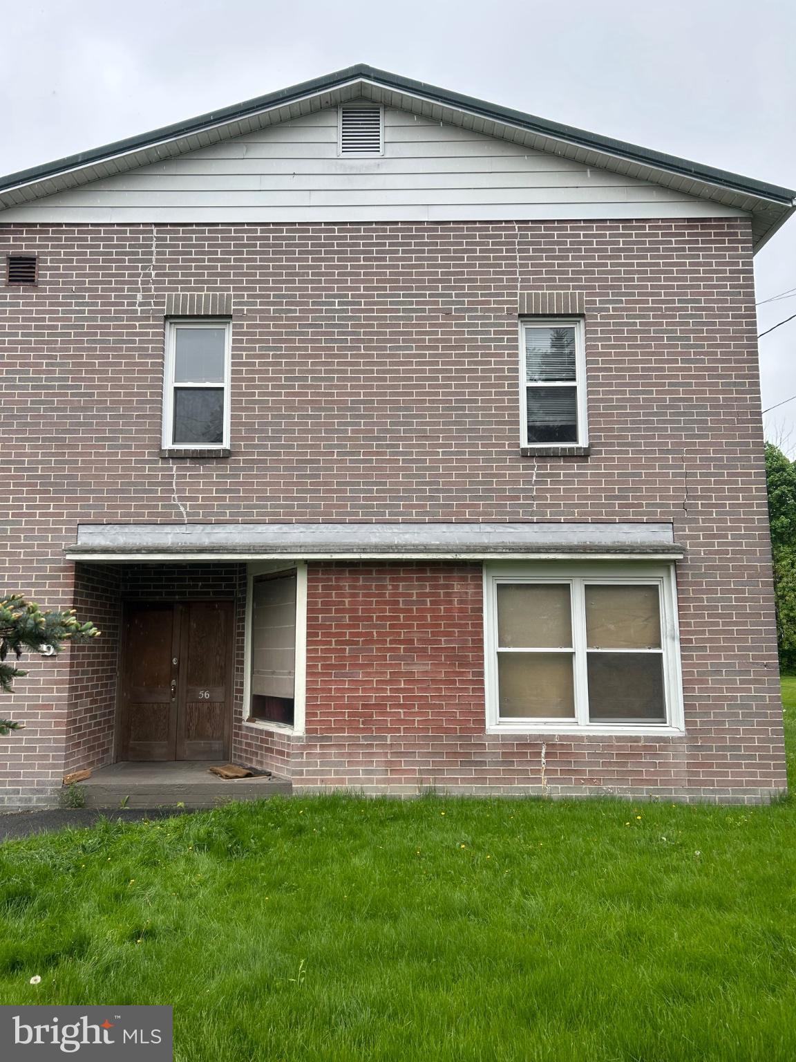 56 Maclay Street Milroy, PA 17063 - Photo 3 of 9 Charming brick facade with lush lawn.