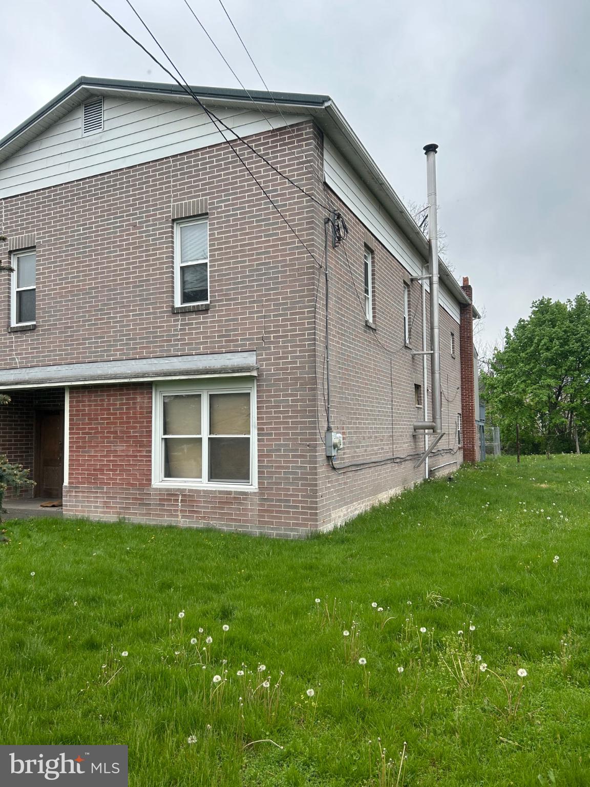 56 Maclay Street Milroy, PA 17063 - Photo 4 of 9 Charming brick home with lush greenery.
