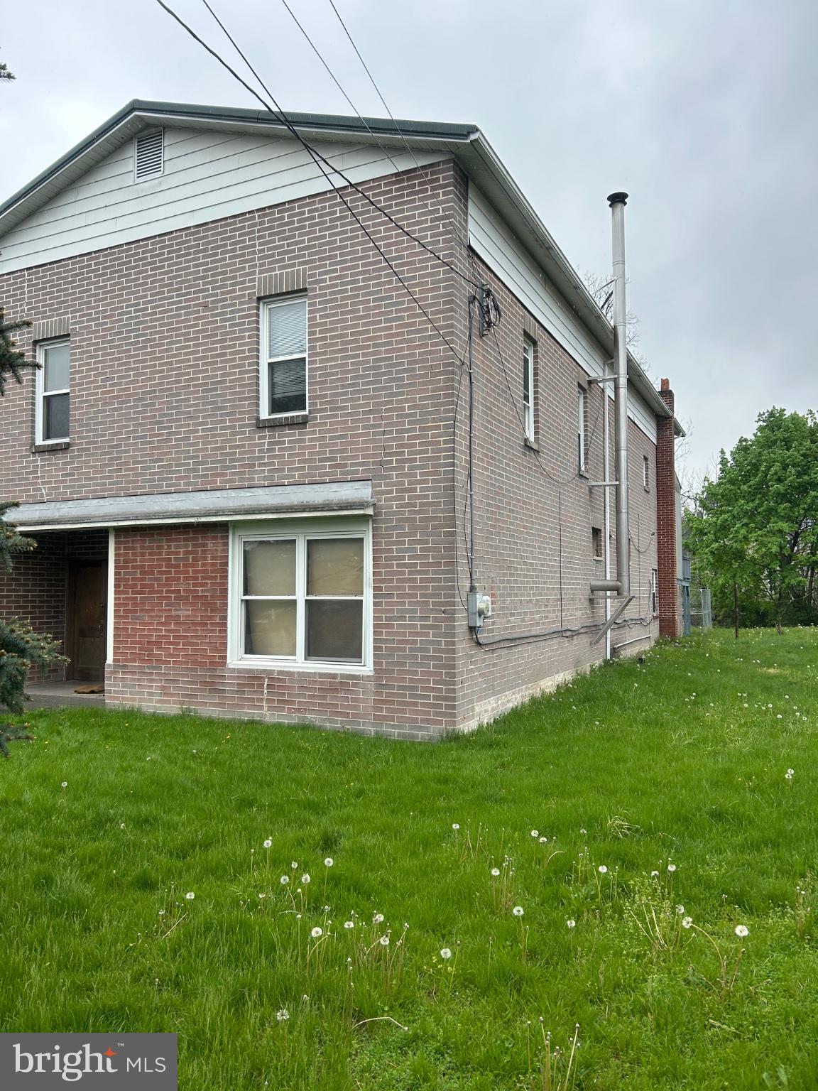 56 Maclay Street Milroy, PA 17063 - Photo 5 of 9 Charming brick home with lush greenery.
