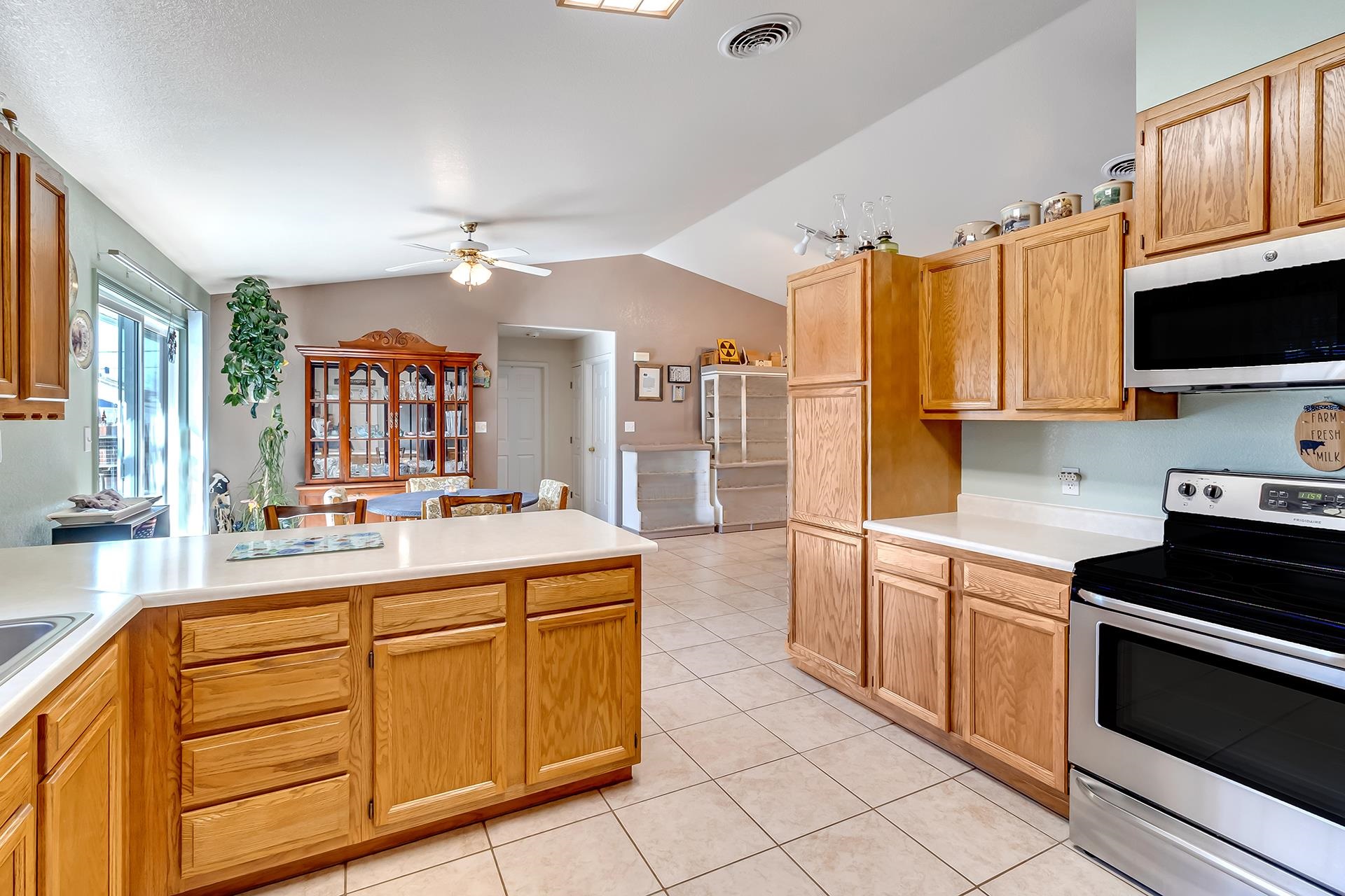 110 Sunset Drive Fruita, CO 81521 - Photo 11 of 39 a large kitchen with stainless steel appliances a stove sink and cabinets