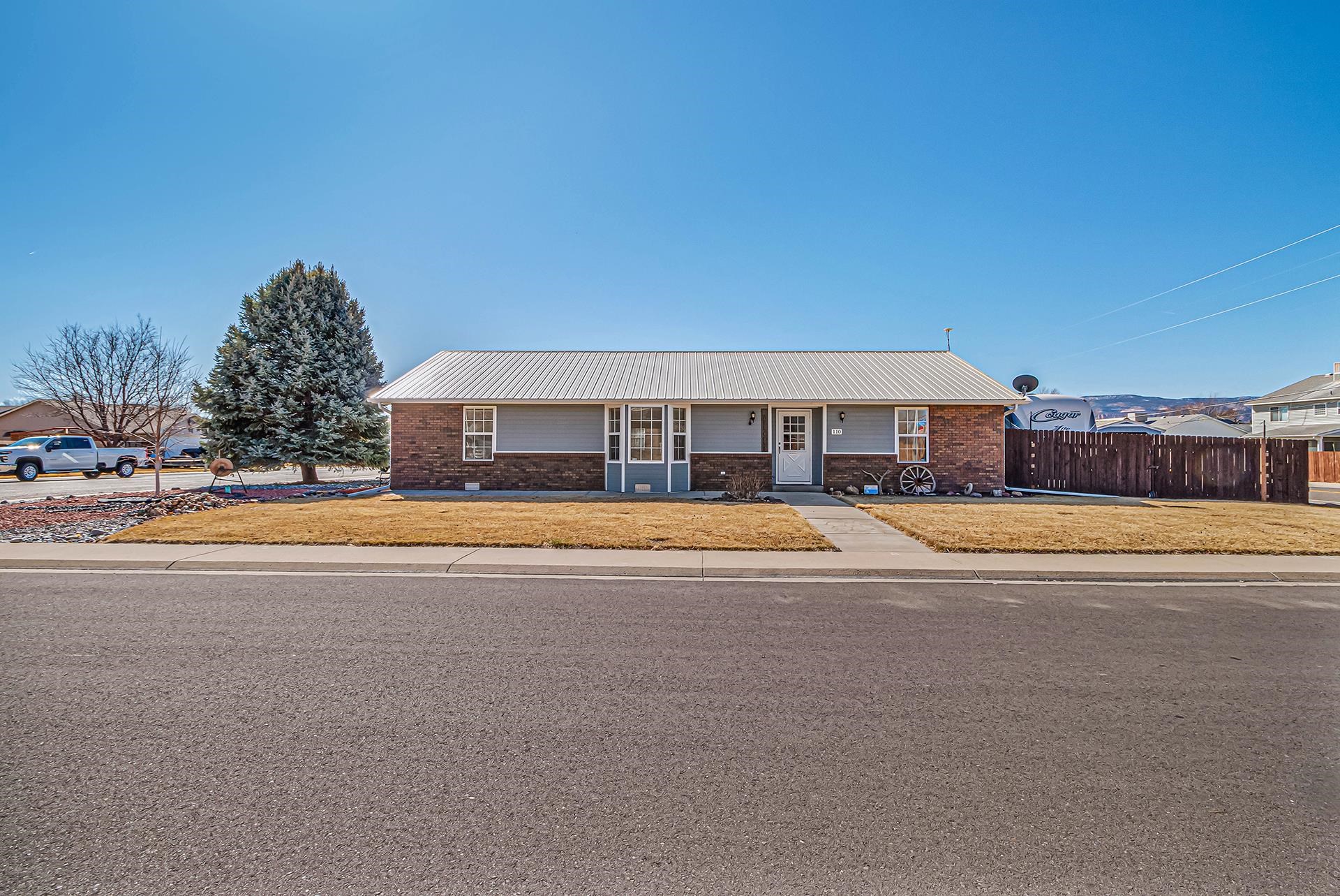 110 Sunset Drive Fruita, CO 81521 - Photo 2 of 39 a view of building with outdoor space and swimming pool