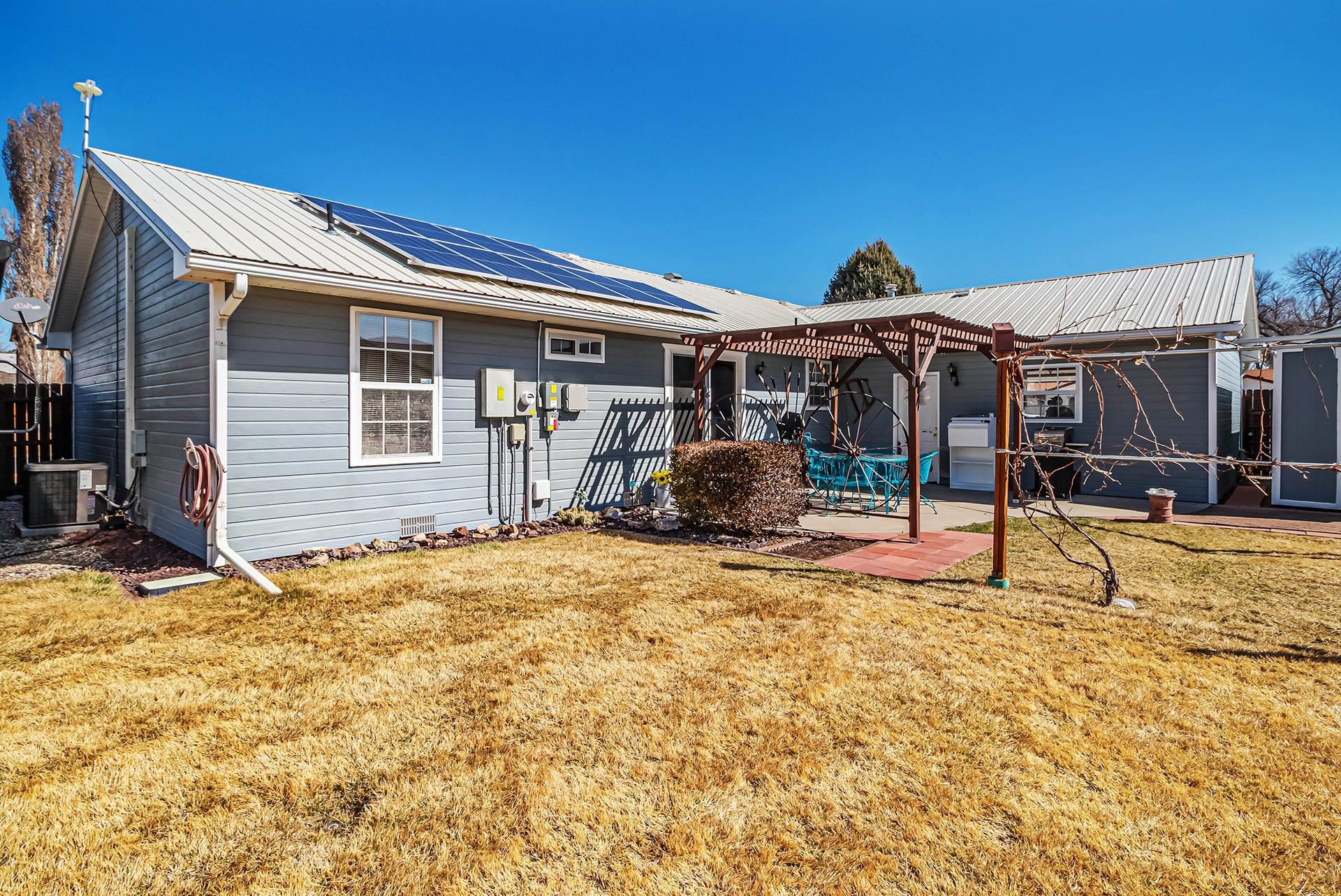 110 Sunset Drive Fruita, CO 81521 - Photo 34 of 39 a view of a house with a backyard and a patio