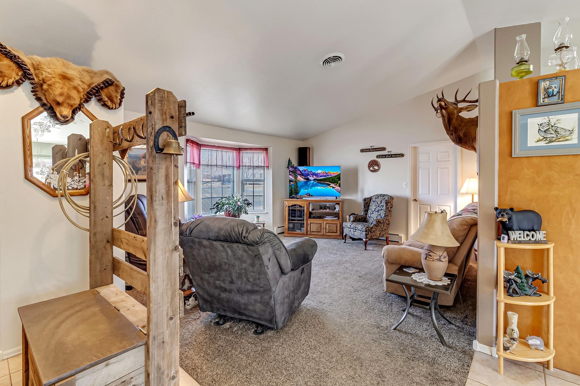 110 Sunset Drive Fruita, CO 81521 - Photo 6 of 39 a living room with furniture and a flat screen tv