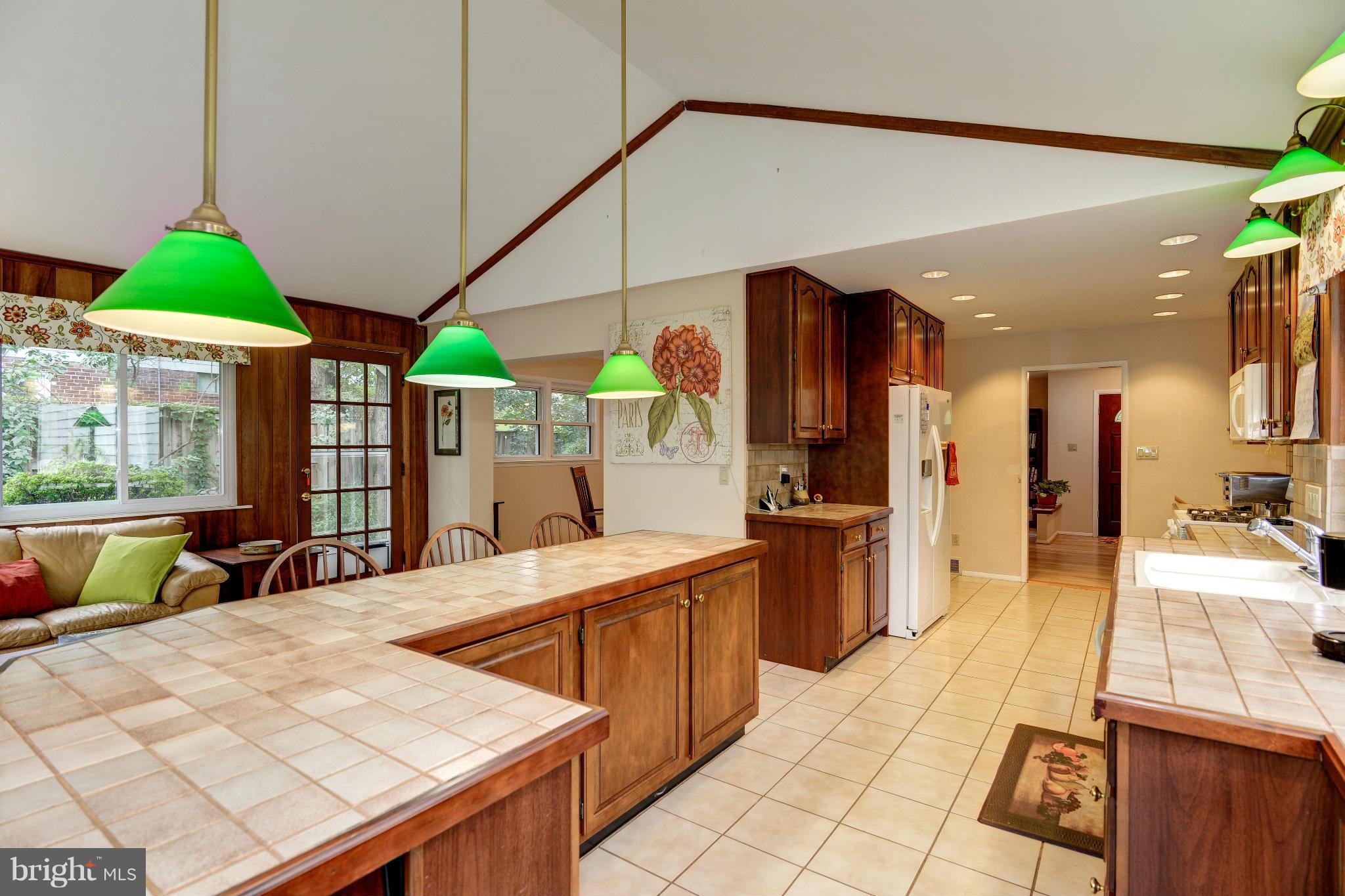 7522 Havelock Street Springfield, VA 22150 - Photo 1 of 30 a large kitchen with stainless steel appliances kitchen island granite countertop a large kitchen island a stove a sink a dining table and chairs