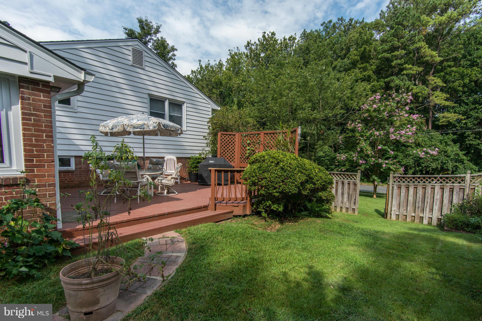 7522 Havelock Street Springfield, VA 22150 - Photo 24 of 30 a view of backyard with table and chairs and potted plants