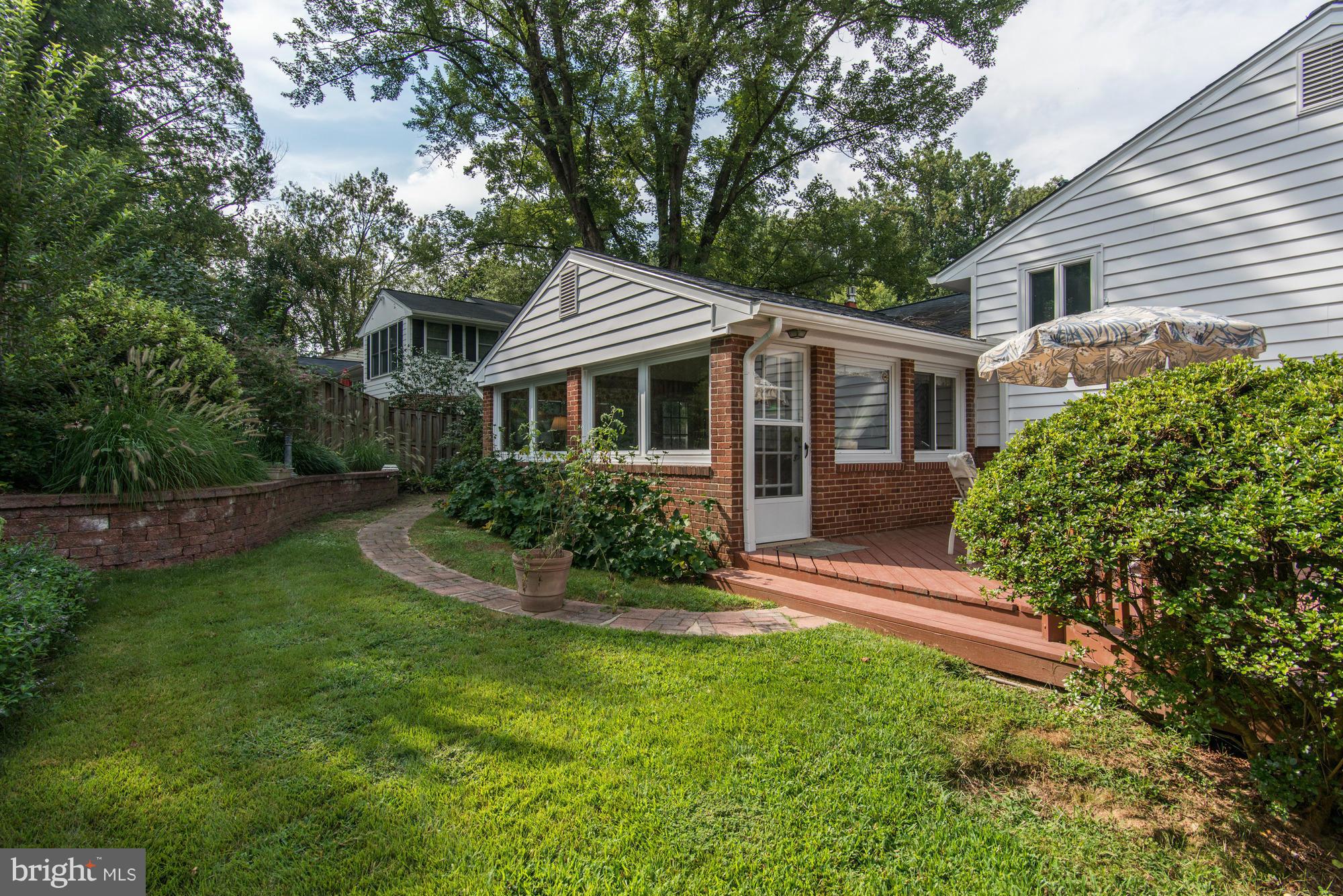 7522 Havelock Street Springfield, VA 22150 - Photo 26 of 30 a view of house with a yard and potted plants