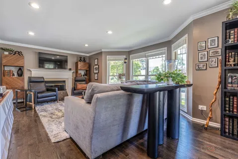 a living room with furniture fireplace and a window