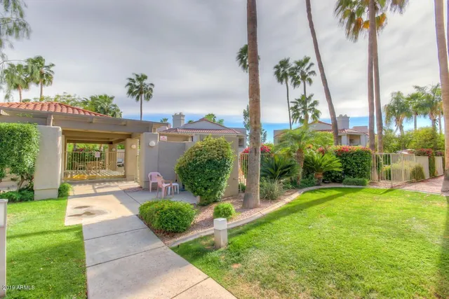 a front view of a house with garden and plants