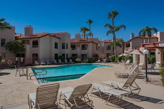 a view of a house with backyard porch and sitting area