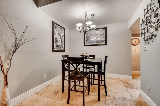 a view of a dining room with furniture and chandelier