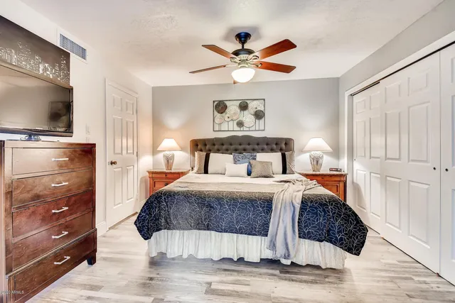 a bedroom with a bed and a flat screen tv